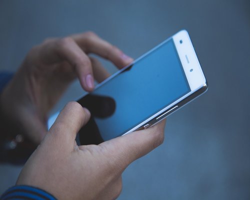 A professional commuting in Jakarta MRT train using smartphone mindfully